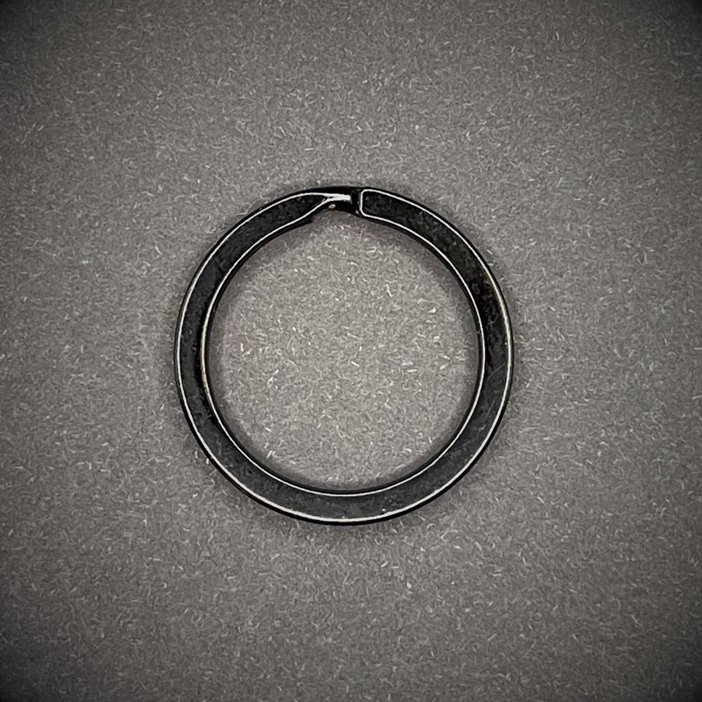 Black Split rings arranged on a dark grey background