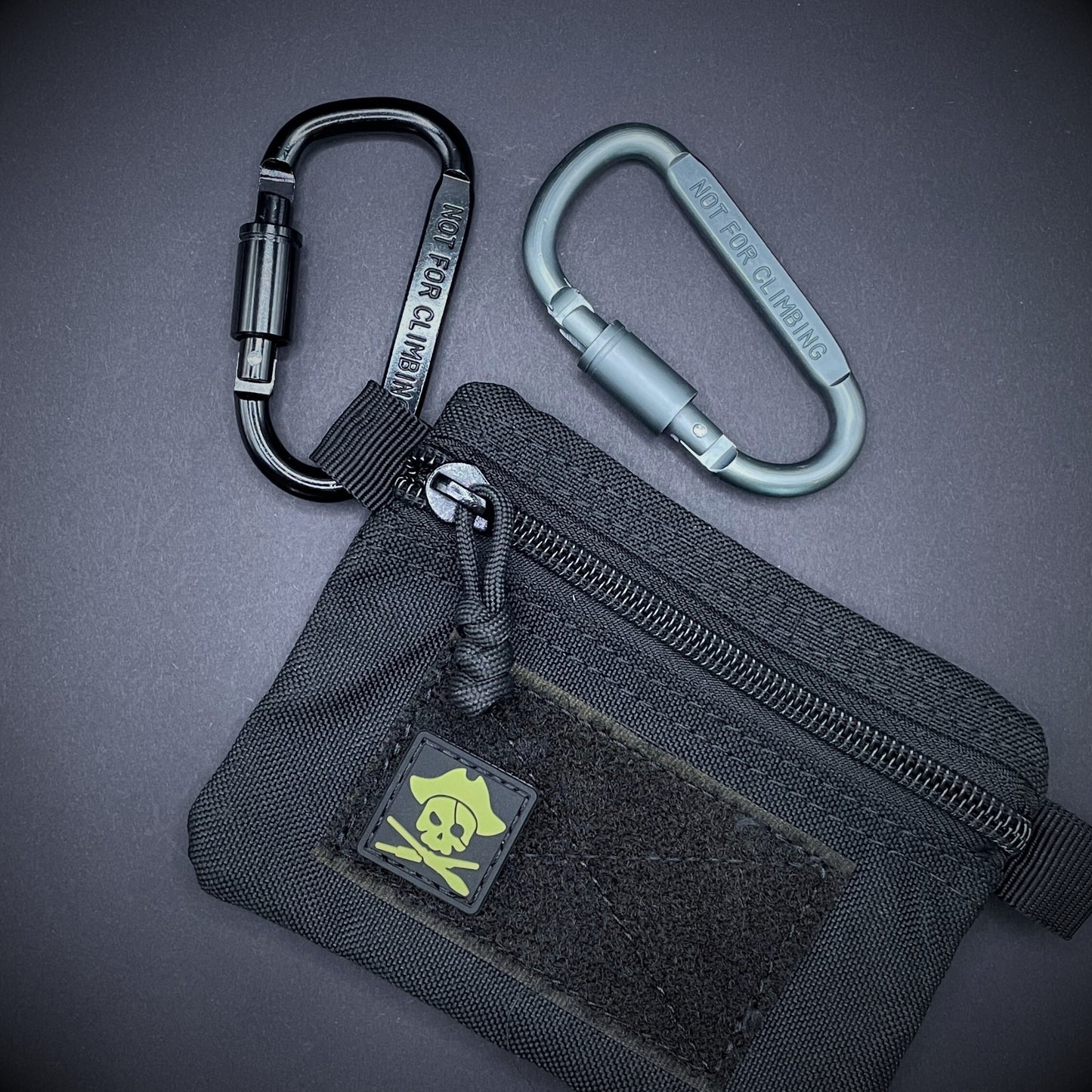 Two carabiners marked 'NOT FOR CLIMBING' clipped to a black pouch.