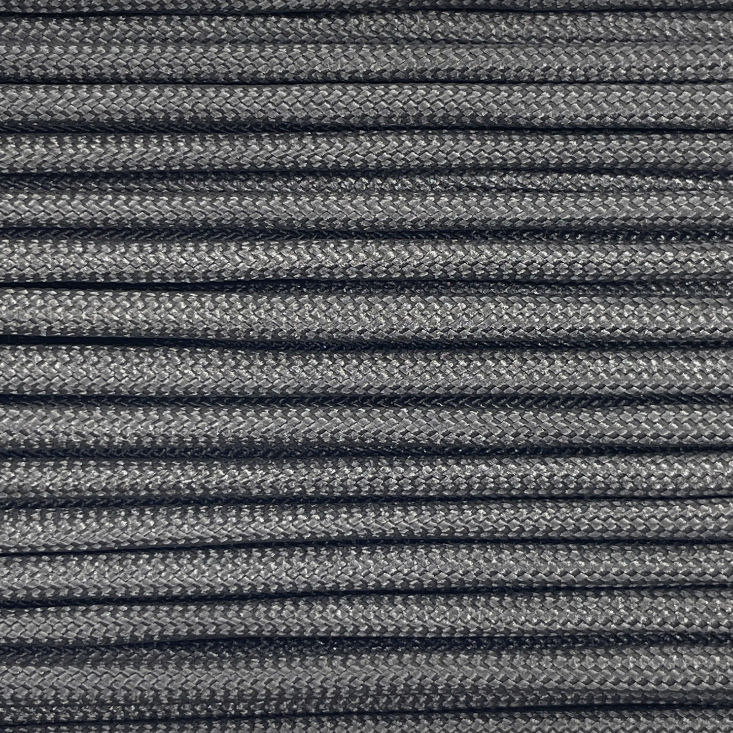 Close-up image of black 550 paracord, showcasing the vibrant colour and texture of the material.