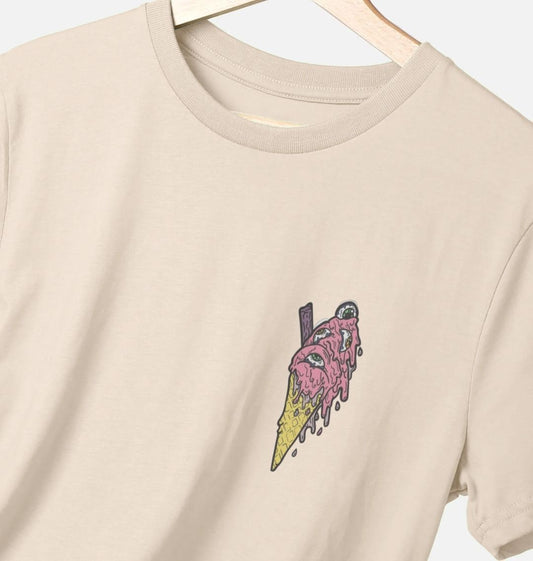 Oat coloured t-shirt on a white background, the t-shirt has an ice cream with eyes in as a logo print.