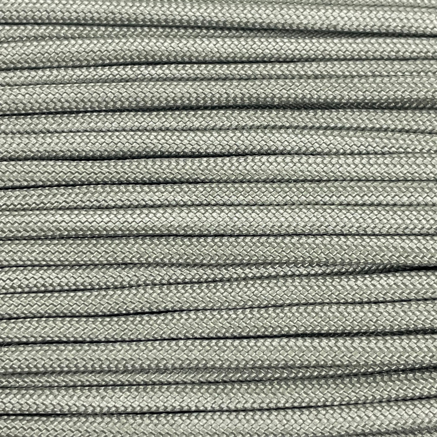 Close-up image of grey green 550 paracord, showcasing the vibrant colour and texture of the material.