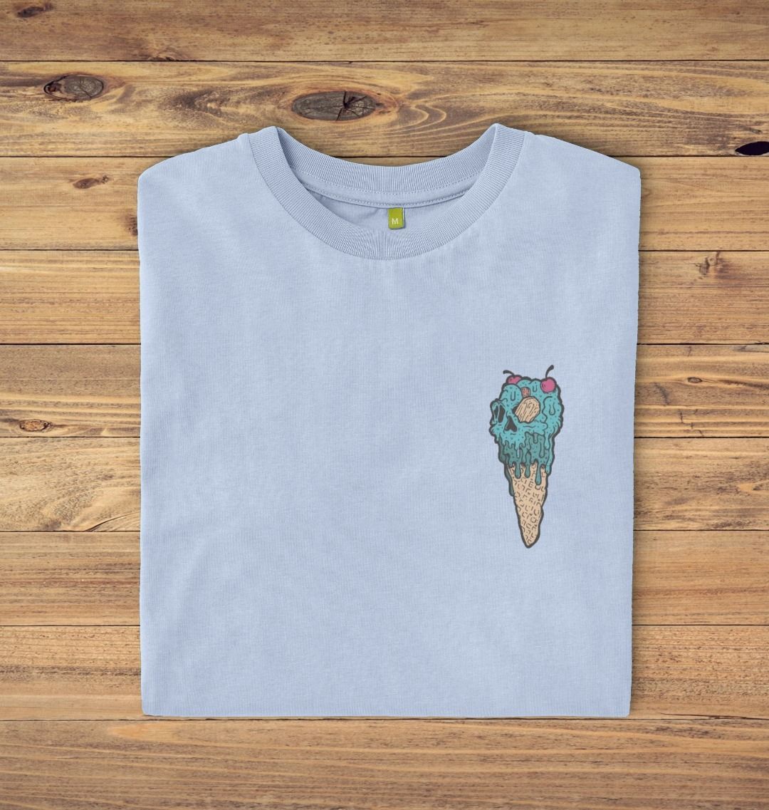 Folded Stone blue t-shirt on a oak panelled background, the t-shirt has an ice cream skull logo print.