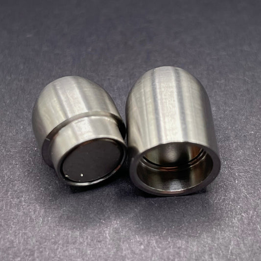 Stainless Steel cylindrical metal magnetic bracelet clasp, displayed on a dark textured background.