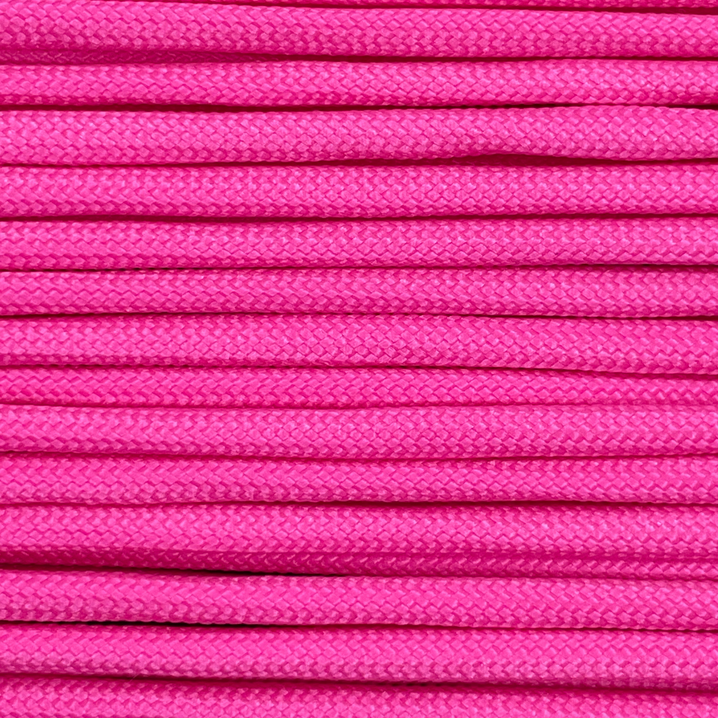 Close-up image of pink 550 paracord, showcasing the vibrant colour and texture of the material.