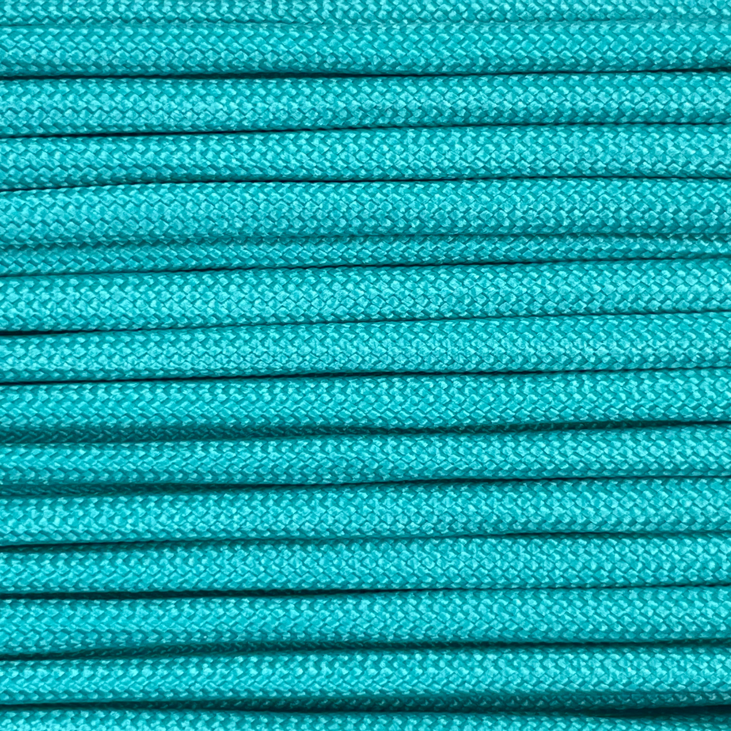 Close-up image of turquoise 550 paracord, showcasing the vibrant colour and texture of the material.