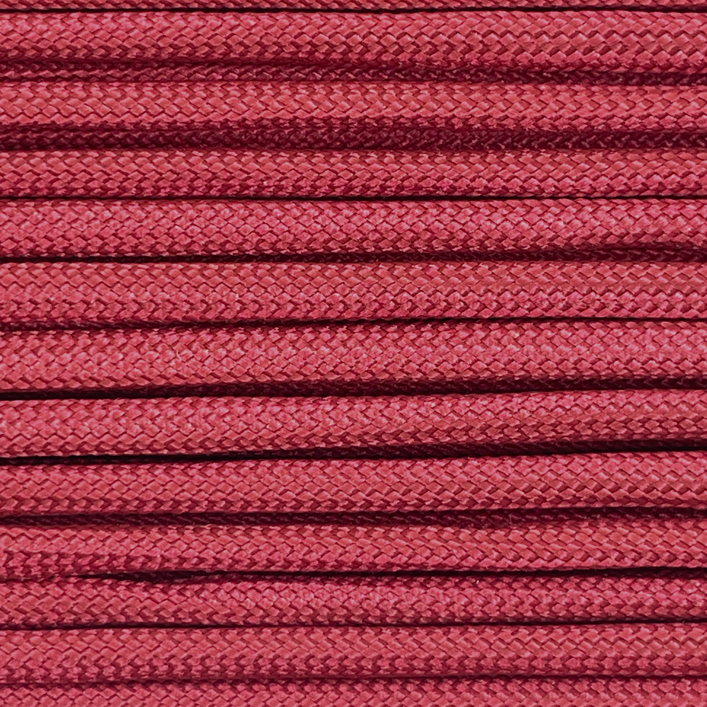 Close-up image of wine red 550 paracord, showcasing the vibrant colour and texture of the material.