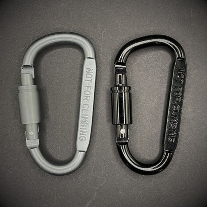 Black and grey carabiner marked 'NOT FOR CLIMBING' on a dark grey background.