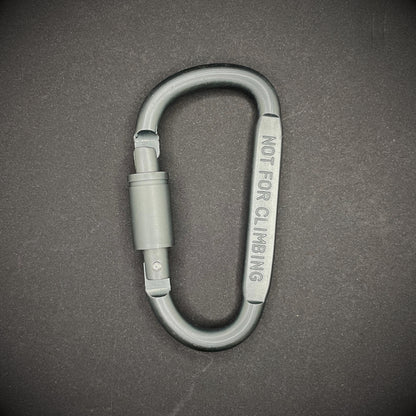 Grey carabiner marked 'NOT FOR CLIMBING' on a dark grey background.