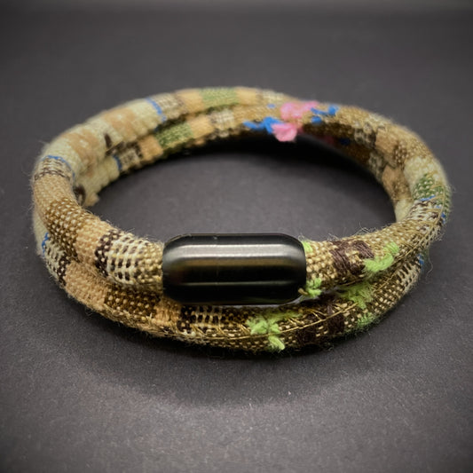 Khaki Boho rope bracelet with black magnetic clasps, displayed on a dark grey surface.