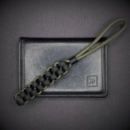 Flat lay of a 3 550 Paracord knife lanyards on a dark grey background