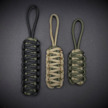 Flat lay of 3 550 Paracord knife lanyards  on a dark grey background