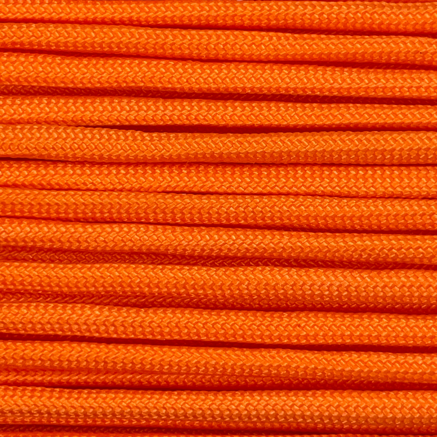 Close-up image of orange 550 paracord, showcasing the vibrant colour and texture of the material.