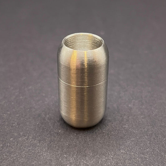 Stainless Steel cylindrical metal magnetic bracelet clasp, displayed on a dark textured background.