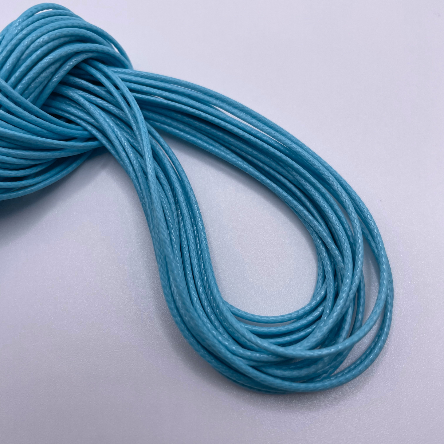 Close-up image of 1mm Waxed Cotton Cord, showcasing the vibrant colour and texture of the material.