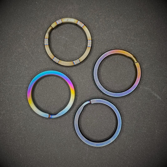 A group of Titanium Split Rings on a dark grey background